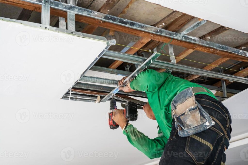 imgi_178_repairman-repairing-ceiling-ceiling-panels-broken-and-damage-from-water-leakage-home-maintenance-and-repair-home-concept-photo